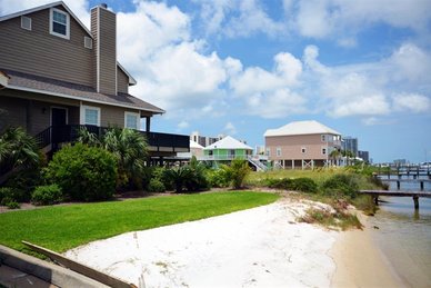 White sandy beach on Old River at Key Harbour townhomes in Perdido Key